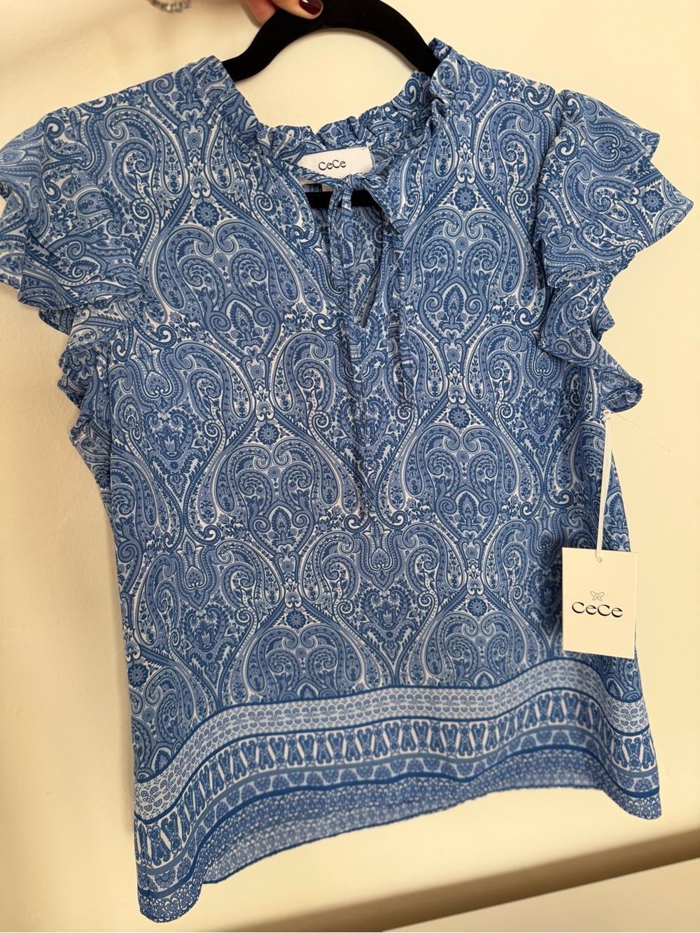 Feminine Lightweight blue blouse with an allover paisley print.